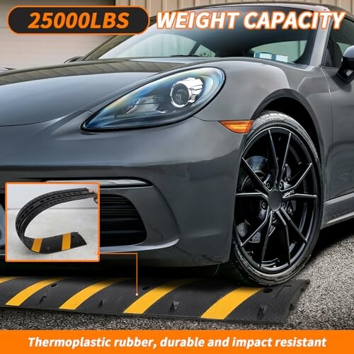 Car on rubber ramp with 25000 lbs weight capacity label.