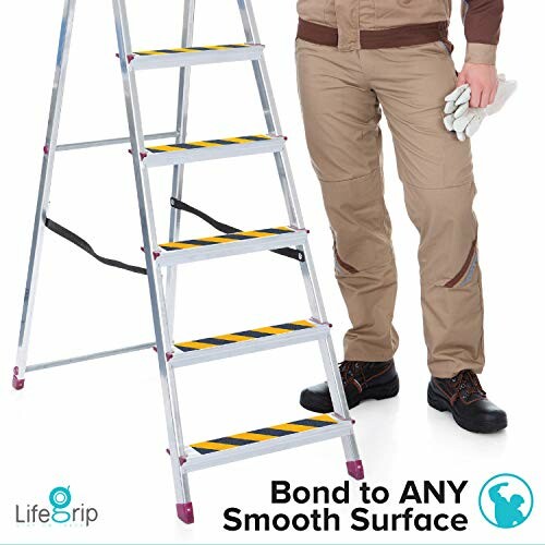 Person standing next to a ladder with safety stripes