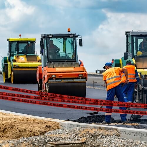 Workers and machinery at a road construction site